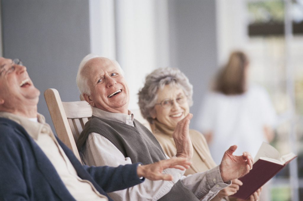 Senior couple at memory care community in chairs