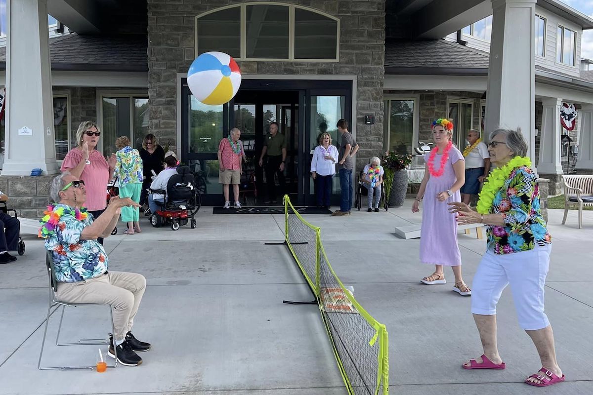 Avail Senior Living | Senior community residents playing with a beach ball at a lua