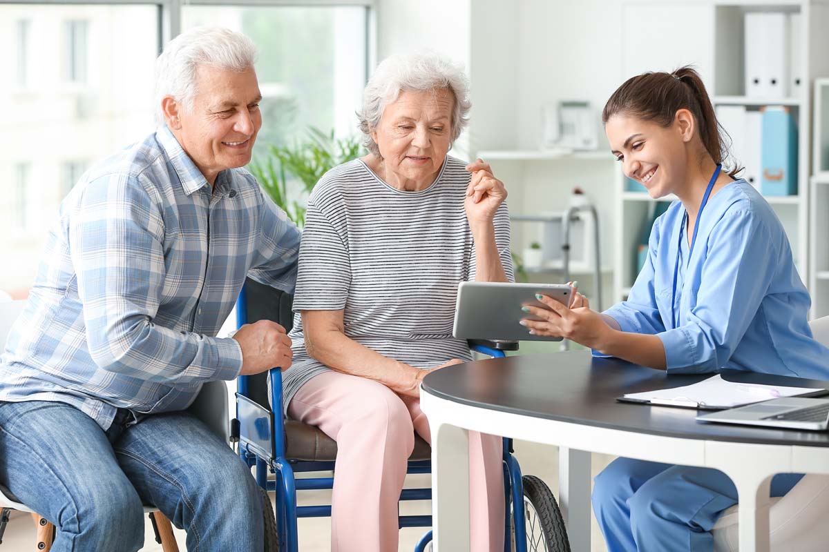 Avail Senior Living | Associate using tablet with seniors