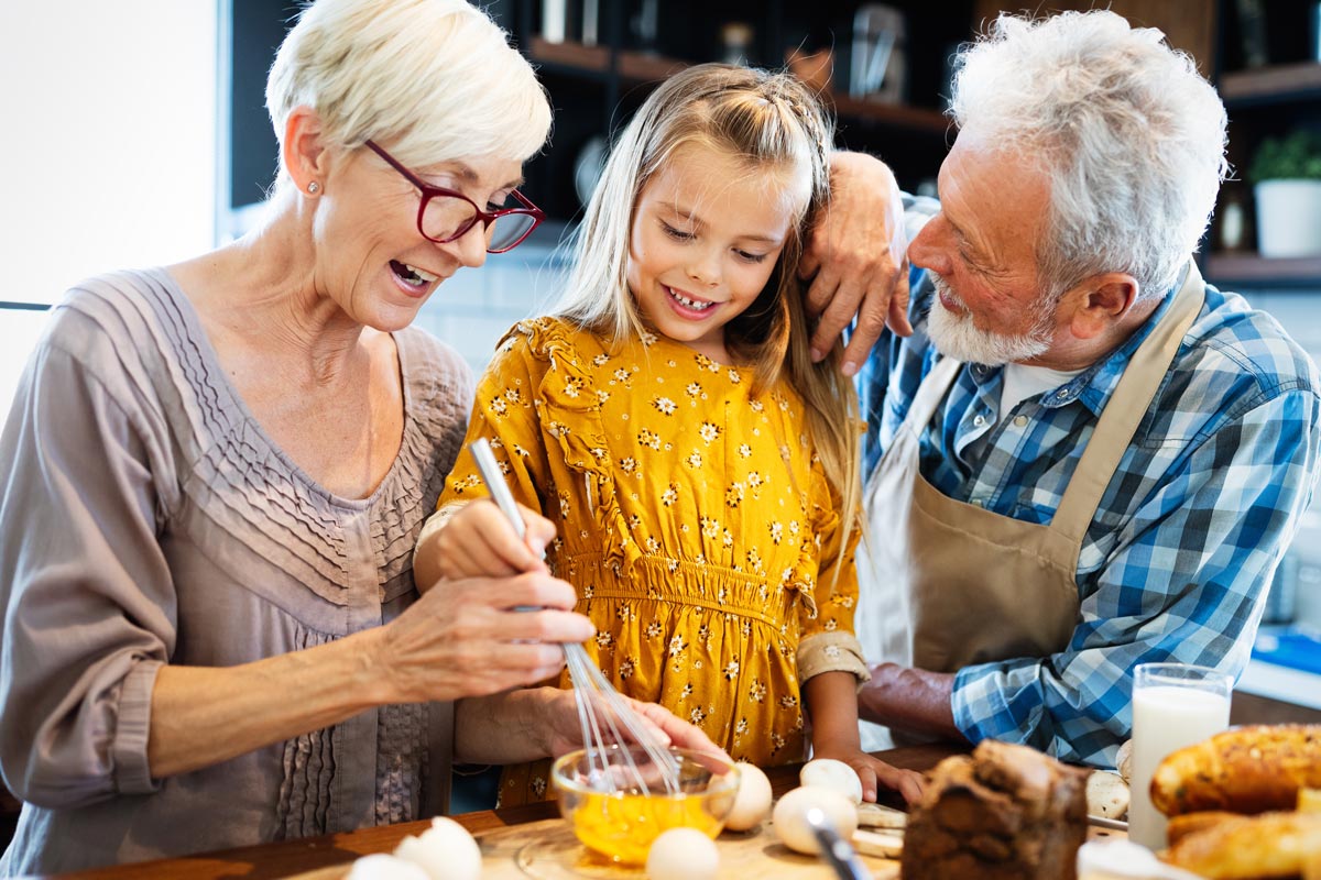 Avail Senior Living | Senior couple cooking with granddaughter