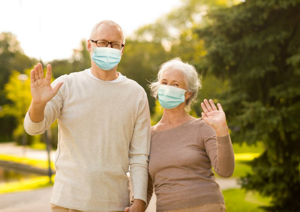 Avail | Seniors outdoors waving in masks