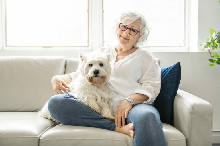 Avail Senior Living | Senior woman and her dog sitting on the couch