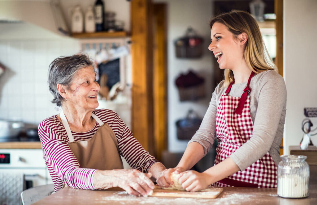 Avail Senior Living | Senior woman and her caregiver cooking