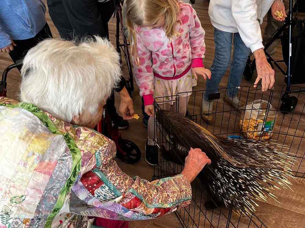 Avail Senior Living | Happy seniors and children next to a porcupine