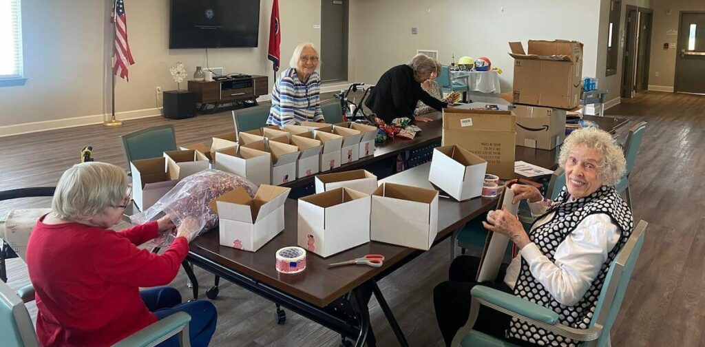 Avail Senior Living | Residents making care packages for the armed forces