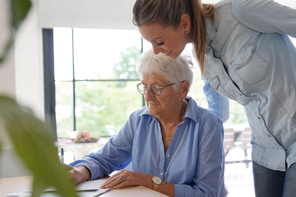 Avail Senior Living | Elderly woman at home writing