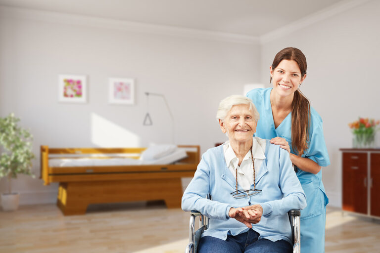 Avail Senior Living | Senior woman in wheelchair smiling with caregiver