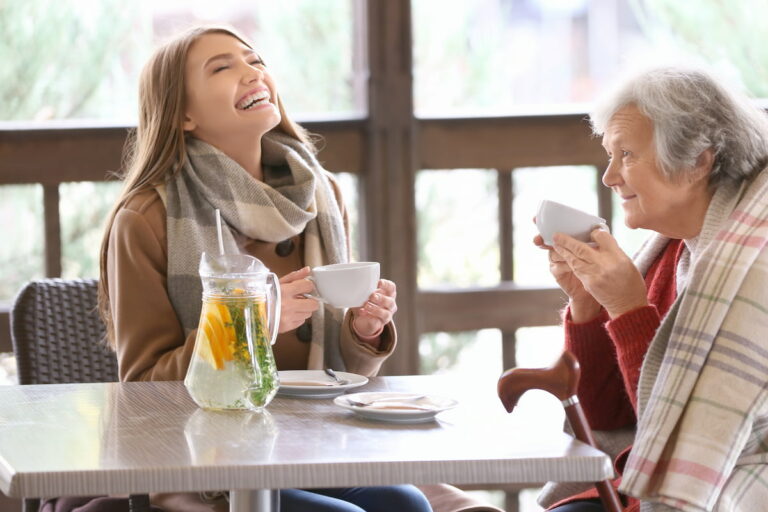 Avail Senior Living | Daughter and senior mother laughing and drinking tea