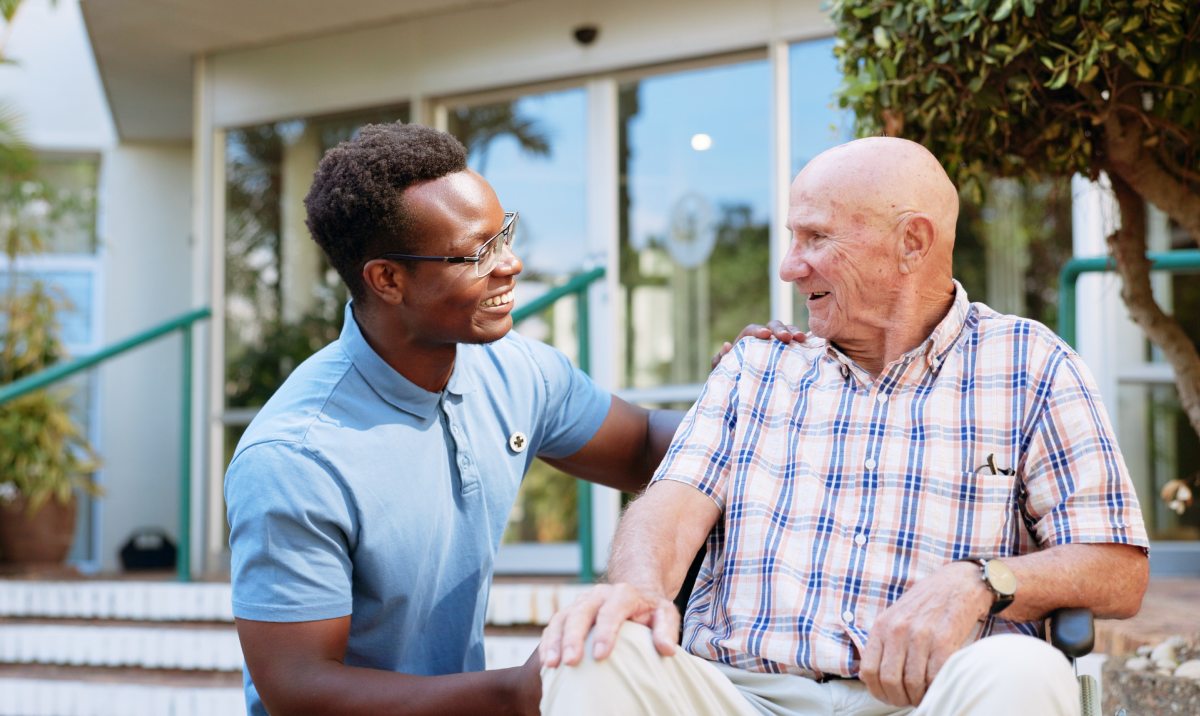 Avail Senior Living | Senior man talking with caregiver